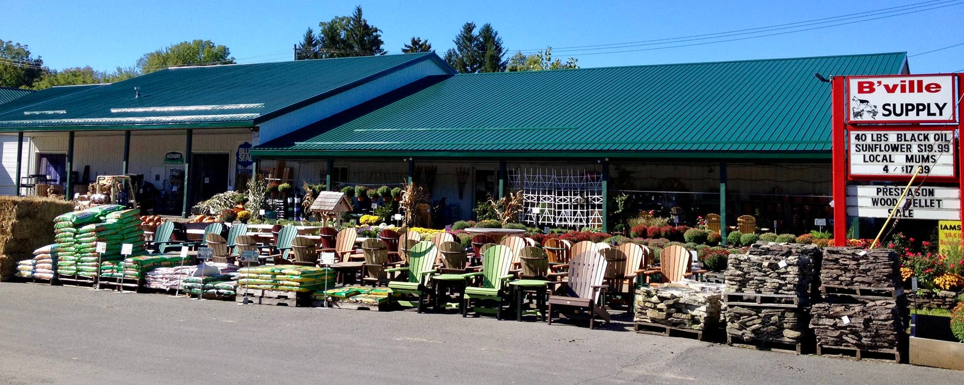 B'Ville Supply store front on a clear day, with supplies on display outside.