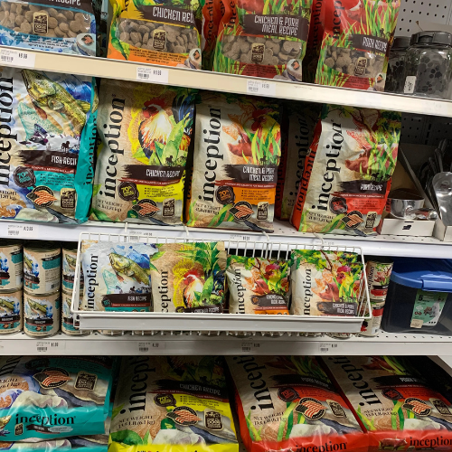 Dog food and supplies displayed inside of B'Ville Supply.